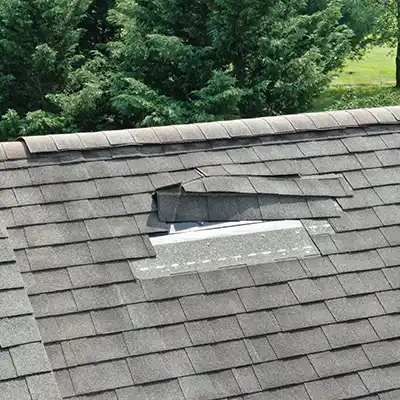 Residential roof with some loose shingles coming off
