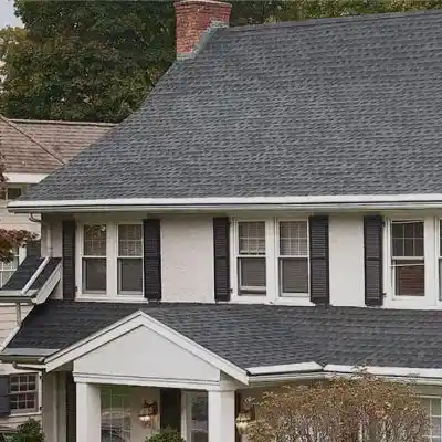 White mid-class home with a gray shingle roof